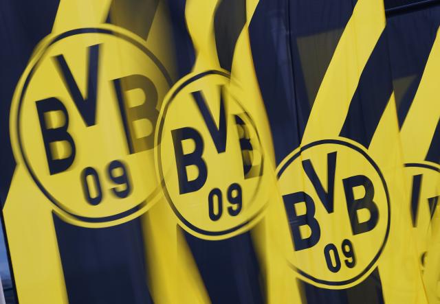 FILED - 25 November 2024, North Rhine-Westphalia, Dortmund: FILE PHOTO - Flags with the Borussia Dortmund (BVB) logo flutter in the wind during the Borussia Dortmund GmbH & Co Annual General Meeting at Westfalenhallen Congress Center. Photo: Bernd Thissen/dpa