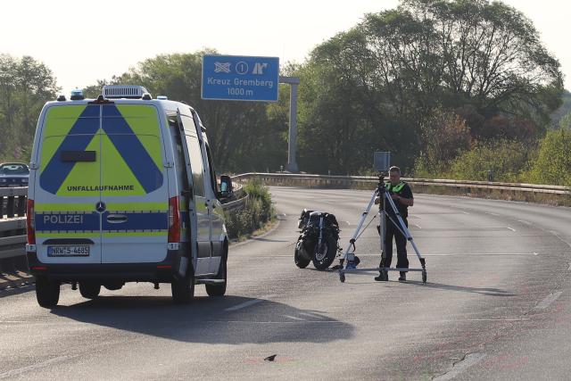 09 August 2026, North Rhine-Westphalia, Cologne: A police officer is collecting evidence with a scanner. Two men were killed in a collision between two motorcycles on the L124 in Cologne. Photo: Sascha Thelen/dpa