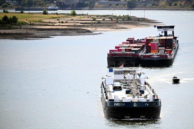 09 August 2026, North Rhine-Westphalia, Duisburg: Cargo ships are sailing on the Rhine despite low water levels. Photo: Federico Gambarini/dpa