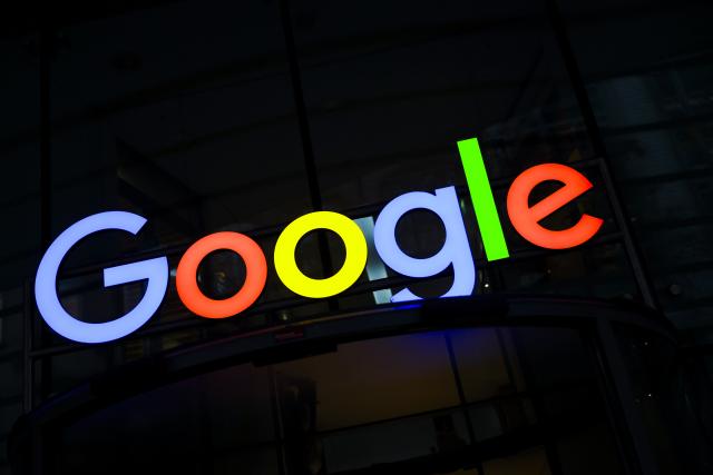 FILED - 01 December 2025, Hamburg: FILE PHOTO - The Google logo shines above the entrance to Google's German headquarters. Photo: Christian Charisius/dpa