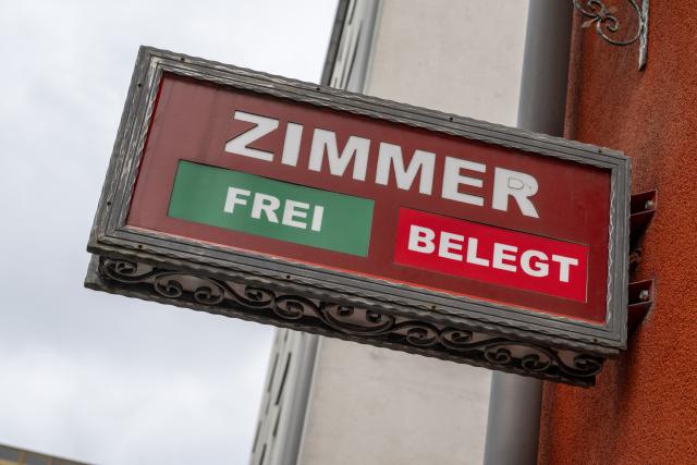 FILED - 27 November 2025, Bavaria, Munich: FILE PHOTO - The words "Rooms - Available - Occupied" are displayed on a sign on the facade of a hotel. Photo: Peter Kneffel/dpa