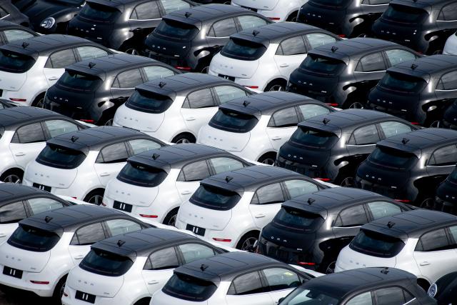 FILED - 25 March 2025, Saxony, Wilhelmshaven: FILE PHOTO - Numerous new Ora cars from the Chinese car manufacturer Great Wall Motor are parked in a parking lot at JadeWeserPort. Photo: Hauke-Christian Dittrich/dpa