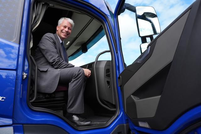 11 August 2026, Schleswig-Holstein, Neumunster: German Transport Minister Steffen Bilger sits in the passenger seat of an electric truck, learning about a ministry-funded project for publicly accessible charging infrastructure for electric cars and trucks, at the Bartels-Langness grocery store location. During his summer tour, Bilger visited various projects in northern Germany. Photo: Marcus Brandt/dpa