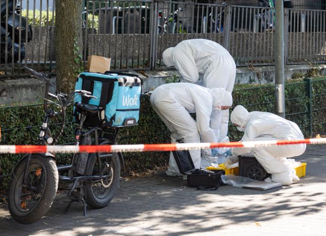 11 August 2026, Hesse, Frankfurt am Main: Forensic investigators work on the scene following a homicide on a public street in Frankfurt. Photo: Boris Roessler/dpa