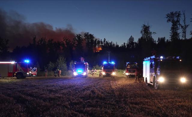 11 August 2026, Saxony, Plauen: Firefighters respond to a fire in a forested area in the Vogtland district. Photo: Mike Müller/dpa