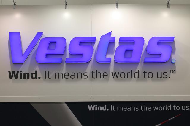 FILED - 18 September 2012, Schleswig-Holstein, Husum: FILE PHOTO - The logo of wind turbine manufacturer Vestas is seen at the Husum WindEnergy trade fair in Husum, Germany. Photo: Christian Charisius/dpa