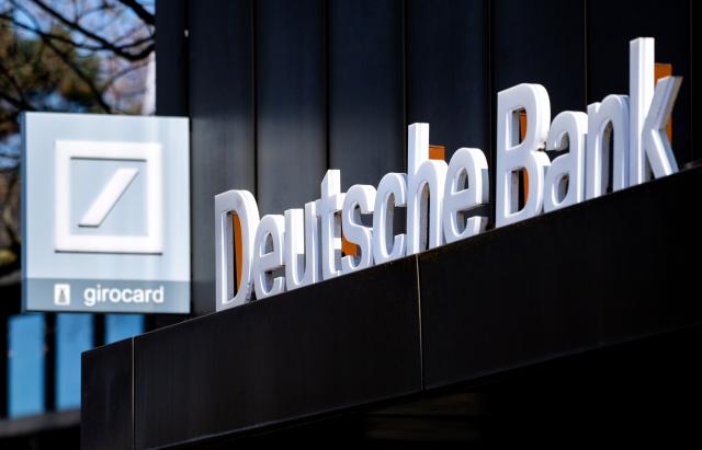 FILED - 24 April 2021, Lower Saxony, Oldenburg: FILE PHOTO - The Deutsche Bank logo is pictured above the entrance of a branch in Oldenburg city center. Photo: Hauke-Christian Dittrich/dpa