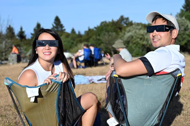 12 August 2026, Hesse, Feldberg: People watch the solar eclipse on the Feldberg. Photo: JEB/dpa