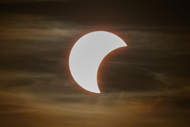 12 August 2026, Saxony, Dresden: The start of a partial solar eclipse can be seen in the sky over Dresden. Photo: Robert Michael/dpa