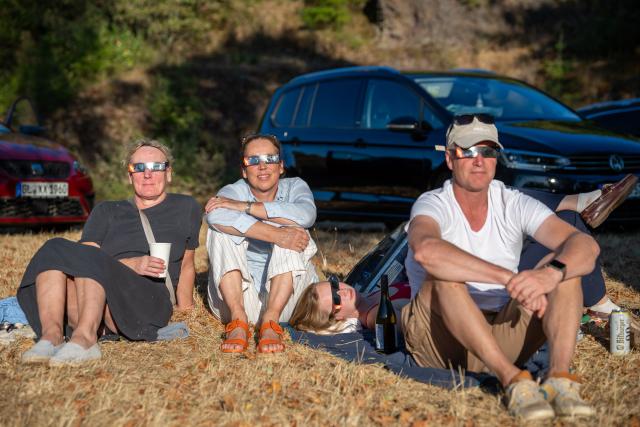 12 August 2026, Rhineland-Palatinate, Schalkenmehren: People watch the partial solar eclipse near the Hoher List Observatory on the L64 near Schalkenmehren in the Eifel region. Photo: Harald Tittel/dpa