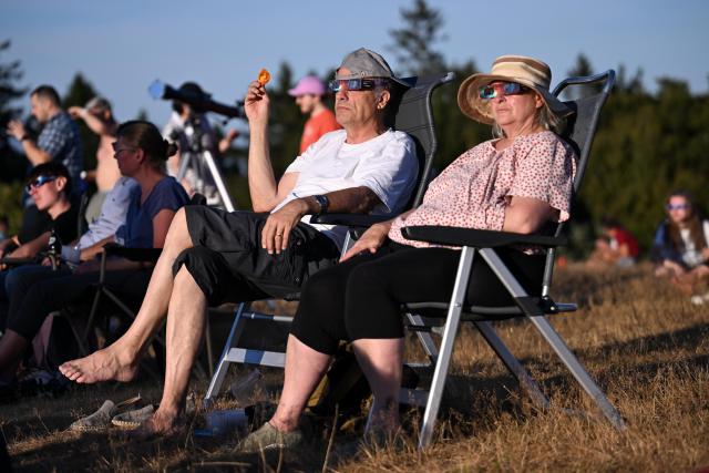 12 August 2026, Hesse, Schmitten: A person watches the solar eclipse on the Feldberg. Photo: Jennifer Brückner/dpa