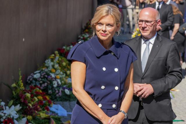 13 August 2026, Berlin: Bundestag President Julia Kloeckner (L) and Berlin's Governing Mayor Kai Wegner stand side by side at the Berlin Wall Memorial before adjusting the ribbons on a wreath placed in front of the steel wall. Several events in Berlin are commemorating the anniversary of the construction of the Berlin Wall. Photo: Sören Stache/dpa
