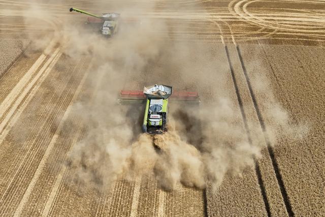 FILED - 30 July 2026, Sachsen-Anhalt, Magdeburg: File Photo - An aerial view taken with a drone shows a farmer drives his combine harvester through the Sohlen Mountains. Photo: Peter Gercke/dpa