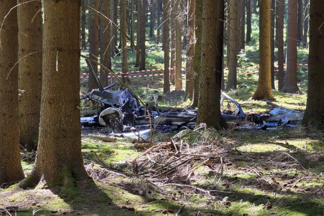 14 August 2026, Saxony, Sehmatal: The wreckage of a helicopter lies in a wooded area. A helicopter crashed in a forest in the Ore Mountains while performing liming work. Photo: Mike Mueller/dpa