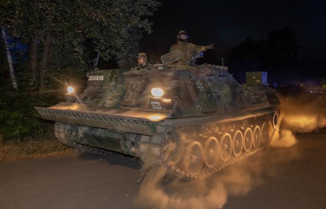 14 August 2026, North Rhine-Westphalia, Huertgenwald: A tank sets off from the operations centre in Kleinhau to fight the forest fire in Huertgenwald by creating firebreaks. Photo: Harald Tittel/dpa