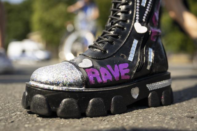 15 August 2026, Berlin: A participant in the "Rave The Planet Parade 2026" demonstration is wearing shoes with the word "Rave" on them.
This is the first major event of its kind in Berlin since the attack on the outskirts of the CSD. Photo: Christophe Gateau/dpa