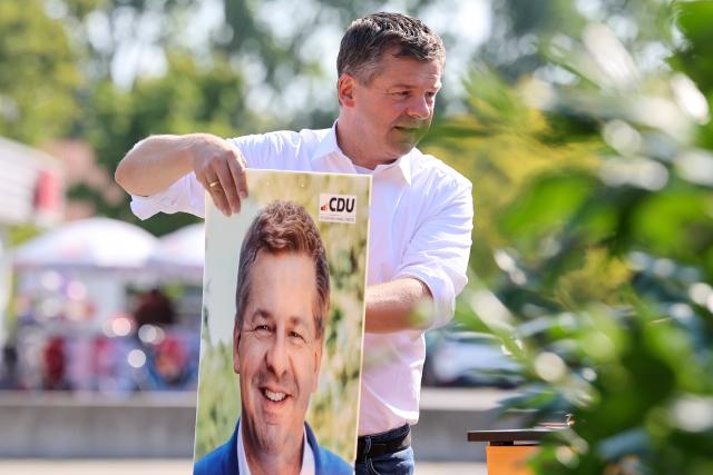 15 August 2026, Saxony-Anhalt, Magdeburg: Sven Schulze, Minister-President and the CDU's top candidate for the 2026 state election in Saxony-Anhalt, visits a CDU information booth. Photo: Peter Gercke/dpa