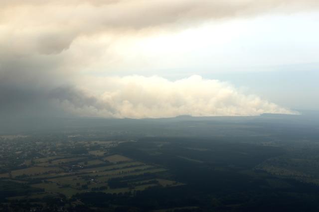 15 August 2026, North Rhine-Westphalia, Hürtgenwald: An aerial view shows the area affected by the wildfire in the Huertgenwald. Several hundred hectares of forest are ablaze in the Hürtgenwald. Photo: Sascha Thelen/dpa