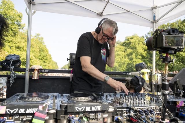 15 August 2026, Berlin: Matthias Roeingh (Dr. Motte) DJing at the "Rave The Planet Parade 2026" demonstration. Photo: Christophe Gateau/dpa