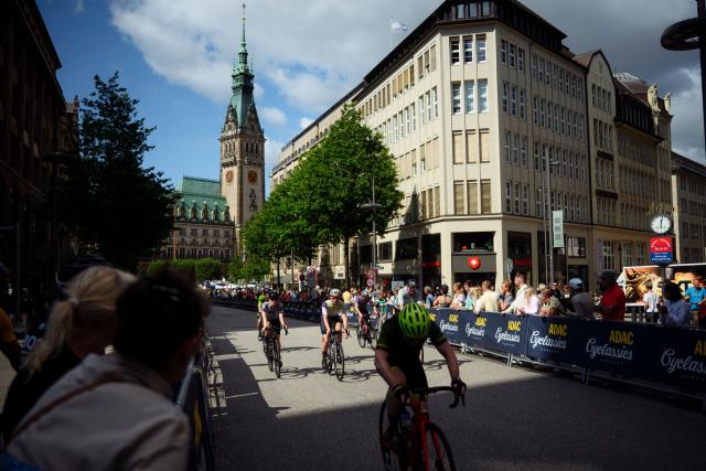 16 August 2026, Hamburg: Participants in the "ADAC Cyclassics" cycling event ride their road bikes down Moenkebergstrasse during the amateur race. Photo: Gregor Fischer/dpa