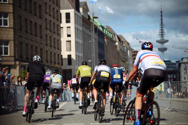 16 August 2026, Hamburg: Participants in the "ADAC Cyclassics" cycling event ride their road bikes along Jungfernstieg during the amateur race. Photo: Gregor Fischer/dpa