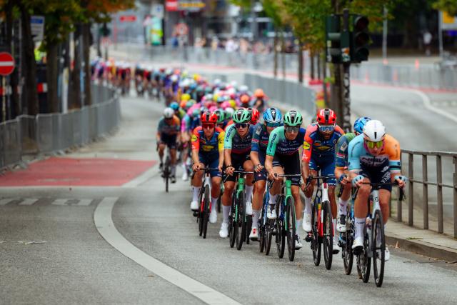 16 August 2026, Hamburg: Cylcists ride their road bikes along the Reeperbahn during the men's 205.3 km race of the UCI Cyclassics World Tour. Photo: Gregor Fischer/dpa