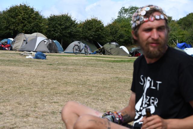 16 August 2026, Schleswig-Holstein, Sylt: A participant sits at the festival grounds as the punk protest camp on Sylt comes to an end on Sunday. Photo: Lea Albert/dpa
