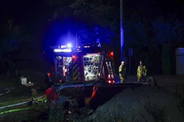 16 August 2026, North Rhine-Westphalia, Monschau: A fire department emergency vehicle pumps water from a stream. Large parts of the High Fens along the border with Germany are affected by the flames. Photo: Thomas Banneyer/dpa