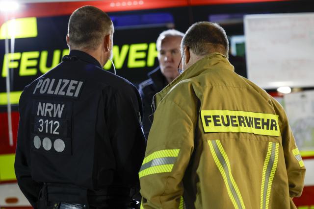 16 August 2026, North Rhine-Westphalia, Monschau: Police and firefighters stand  at the command center. Large parts of the High Fens along the border with Germany are affected by the flames. Photo: Thomas Banneyer/dpa