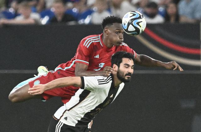 FILED - 20 June 2023, North Rhine-Westphalia, Gelsenkirchen: FILE PHOTO - Colombia's Jhon Lucumi (L) and Germany's Ilkay Guendogan battle for the ball during the International friendly soccer match between Germany and Colombia at Veltins Arena. Photo: Bernd Thissen/dpa