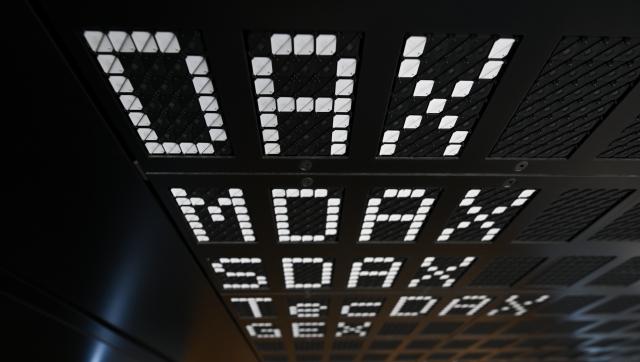 FILED - 21 February 2024, Hesse, Frankfurt/Main: FILE PHOTO - The Deutsche Boerse indices are displayed on a scoreboard in the trading floor of the Frankfurt Stock Exchange. Photo: Arne Dedert/dpa