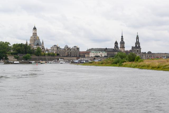 18 August 2026, Saxony, Dresden: A view across the Elbe River toward the historic Old Town skyline, featuring the Frauenkirche (L-R), the dome of the Academy of Fine Arts with the angel "Fama," the Ständehaus, the Hausmann Tower, and the Hofkirche. Photo: Robert Michael/dpa