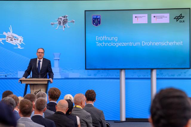 18 August 2026, Saxony-Anhalt, Hecklingen: Alexander Dobrindt (CSU), German Minister of the Interior, speaks at the opening of the Technology Center for Drone Safety at the German Aerospace Center (DLR) facility in the Cochstedt district. Photo: Klaus-Dietmar Gabbert/dpa