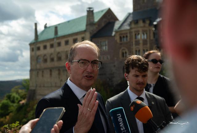 19 August 2026, Thuringia, Eisenach: Alexander Dobrindt, German Minister of the Interior, speaks to the cameras at a viewing platform at Wartburg Castle near Eisenach in Thuringia. During his summer tour, Dobrindt is visiting various emergency response teams in Thuringia and Hesse. Photo: Katharina Kausche/dpa