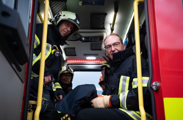 19 August 2026, Thuringia, Eisenach: German Interior Minister Alexander Dobrindt (R) sits in a fire truck during a training exercise by the Eisenach Fire Department. During his summer tour, Dobrindt is visiting various emergency response teams in Thuringia and Hesse. Photo: Katharina Kausche/dpa pool/dpa