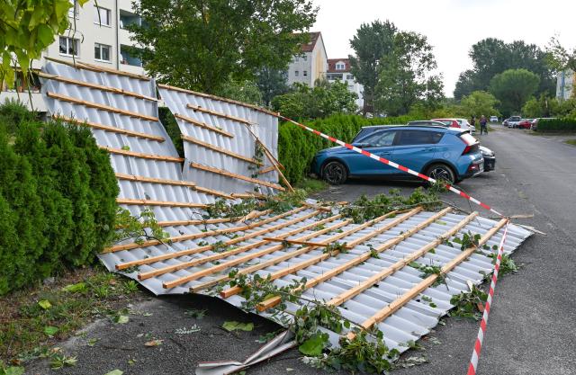 20 August 2026, Brandenburg, Fuerstenwalde/Spree: The metal roof of a preschool lies on the street after a tornado. The German Weather Service has confirmed that a tornado struck Fuerstenwalde/Spree in Brandenburg. Photo: Patrick Pleul/dpa