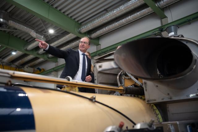 20 August 2026, Hesse, Fuldatal: Alexander Dobrindt, German Minister of the Interior, inspects a helicopter belonging to the Federal Police Air Squadron in Fuldatal inside a maintenance hangar. During his summer tour, Dobrindt is visiting various law enforcement agencies in Thuringia and Hesse. Photo: Katharina Kausche/dpa-Pool/dpa