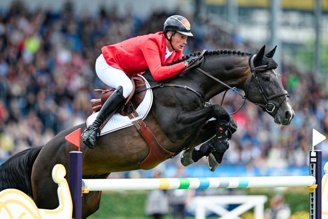 20 August 2026, North Rhine-Westphalia, Aachen: German show jumper Daniel Deusser, riding Otello de Guldenboom, clears an obstacle during the 2nd qualifying round, 1st round of the Nations Cup, at the 2026 FEI World Championships in Aachen. Photo: Uwe Anspach/dpa
