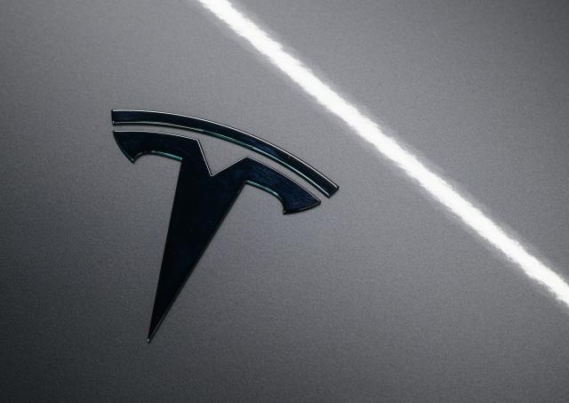 FILED - 01 September 2025, Brandenburg, Gruenheide: FILE PHOTO - The Tesla logo is seen on a vehicle at the Tesla Gigafactory Berlin-Brandenburg. Photo: Patrick Pleul/dpa