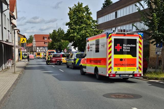 SCREENSHOT - 21 August 2026, Hesse, Hofgeismar: Emergency vehicles are on the scene, where a car crashed into the wall of a department store. Police headquarters reported that, the car-which is said to have been traveling at high speed through the pedestrian zone-apparently struck several people. At least one person is reported to have been injured as a result this morning. Photo: ---/HessenNewsTV/dpa