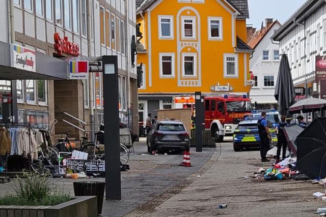 SCREENSHOT - 21 August 2026, Hesse, Hofgeismar: Emergency vehicles are on the scene, where a car crashed into the wall of a department store. Police headquarters reported that, the car-which is said to have been traveling at high speed through the pedestrian zone-apparently struck several people. At least one person is reported to have been injured as a result this morning. Photo: ---/HessenNewsTV/dpa