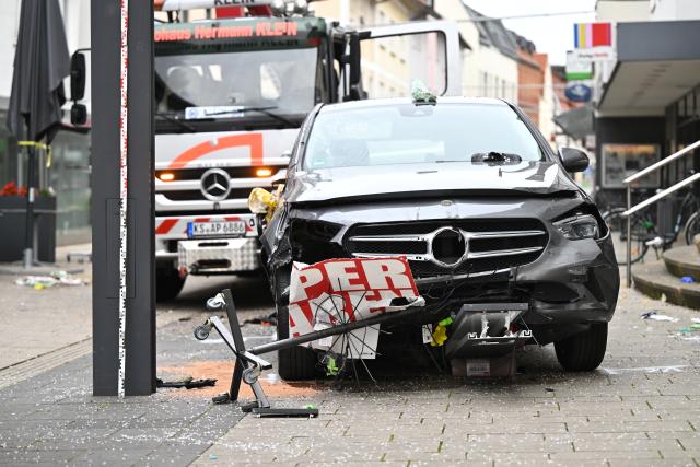 21 August 2026, Hesse, Hofgeismar: A damaged car is seen near the scene where a car sped through the pedestrian zone at high speed in Hofgeismar. Photo: Florian Wiegand/dpa