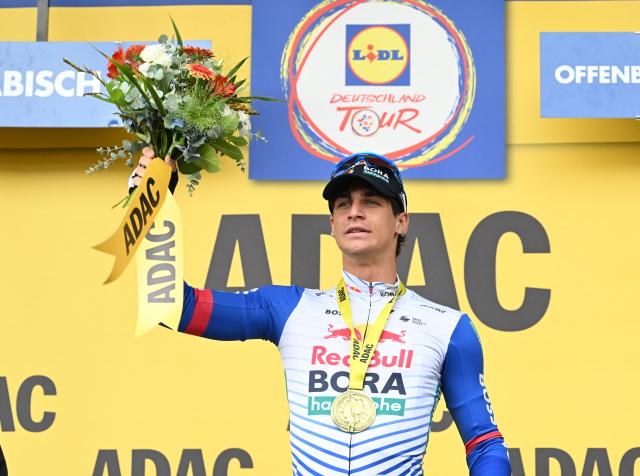 21 August 2026, Rhineland-Palatinate, Offenbach an der Queich: Italian cyclist Alessio Magagnotti of team Red Bull-Bora Hansgrohe celebrates on the podium after winning the second stage of the Tour of Germany cycling race, 196.80 Km from Schwaebisch Hall to Offenbach an der Queich. Photo: Uli Deck/dpa