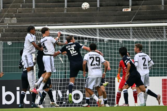 21 August 2026, North Rhine-Westphalia, Krefeld: Eintracht Frankfurt's Robin Koch (2nd L) scores his side's second goal during the German DFB Cup first Round soccer match between SC St. Toenis 11/20 and Eintracht Frankfurt at the Grotenburg Stadium. Photo: Federico Gambarini/dpa - IMPORTANT NOTICE: In accordance with the regulations of the Bundesliga and the German Football Association (DFB), it is prohibited to use or allow the use of photographs taken in the stadium and/or during the game in the form of sequential images and/or video-like photo series.