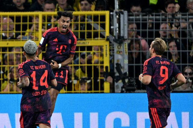 22 August 2026, Dortmund: Bayern Munich's Nathaniel Brown celebrates with teammate Luis Diaz during the German Franz Beckenbauer Supercup soccer match between Borussia Dortmund and FC Bayern Munich at the Signal Iduna Park. Photo: Federico Gambarini/dpa - IMPORTANT NOTICE: Bundesliga and DFB regulations prohibit any use of photographs as image sequences and/or quasi-video.