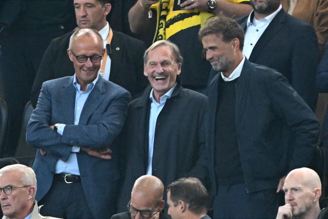 22 August 2026, Dortmund: German Chancellor Friedrich Merz, Dortmund president and DFB vice-president Hans-Joachim Watzke, and national team coach Jurgen Klopp attend the German Franz Beckenbauer Supercup soccer match between Borussia Dortmund and FC Bayern Munich at the Signal Iduna Park. Photo: Federico Gambarini/dpa - IMPORTANT NOTICE: Bundesliga and DFB regulations prohibit any use of photographs as image sequences and/or quasi-video.