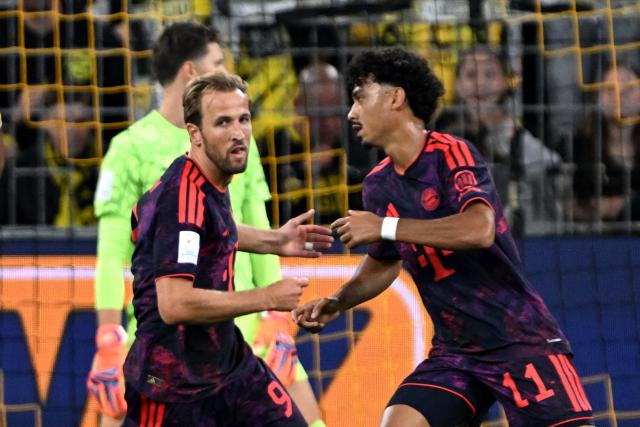 22 August 2026, Dortmund: Bayern Munich's Nathaniel Brown celebrates scoring his side's first goal with teammate Harry Kane during the German Franz Beckenbauer Supercup soccer match between Borussia Dortmund and FC Bayern Munich at the Signal Iduna Park. Photo: Federico Gambarini/dpa - IMPORTANT NOTICE: Bundesliga and DFB regulations prohibit any use of photographs as image sequences and/or quasi-video.