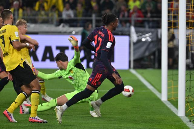 22 August 2026, Dortmund: Bayern Munich's Michael Olise scores his side's second goal during the German Franz Beckenbauer Supercup soccer match between Borussia Dortmund and FC Bayern Munich at the Signal Iduna Park. Photo: Bernd Thissen/dpa - IMPORTANT NOTICE: Bundesliga and DFB regulations prohibit any use of photographs as image sequences and/or quasi-video.