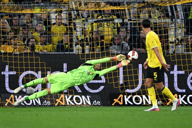 22 August 2026, Dortmund: Borussia Dortmund goalkeeper Gregor Kobel dives for the ball during the German Franz Beckenbauer Supercup soccer match between Borussia Dortmund and FC Bayern Munich at the Signal Iduna Park. Photo: Federico Gambarini/dpa - IMPORTANT NOTICE: Bundesliga and DFB regulations prohibit any use of photographs as image sequences and/or quasi-video.