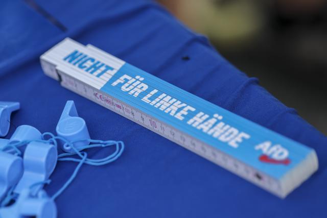 21 August 2026, Saxony-Anhalt, Querfurt: A folding ruler bearing the AfD logo and the inscription "Not for left-handed people" is on display at one of the party's information booths for the state election in Saxony-Anhalt. Photo: Jan Woitas/dpa